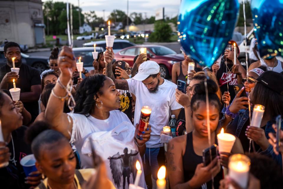 Dwayne Taylor, center, of Lincoln Park, holds his head down with family and friends while attending a vigil  Friday, June 4, 2021, for his cousin William Chavois, who was shot  and killed outside of Society Detroit, a club on the city's east side. "It makes me want to go harder. A lot of people can't just fight and get their ass whooped. They're quick to pull a gun and take somebody's life. They don't even think twice before they do it," said Taylor, who runs his Pick Your Poison Detroit boxing events as an alternative for people to avoid gun violence.