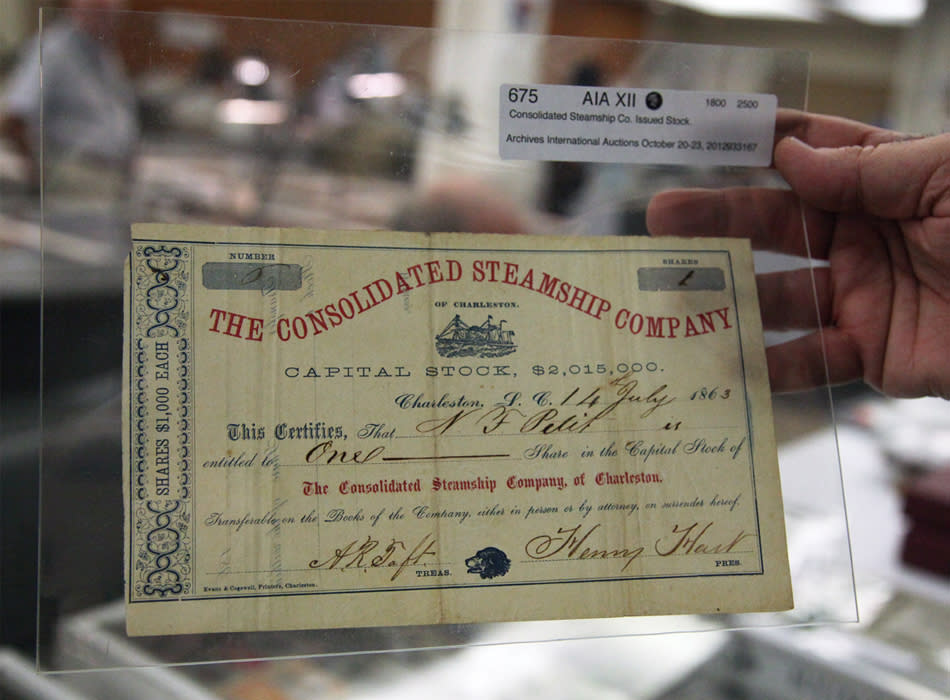 Dr. Robert Schwartz holds a stock certificate for one share of the Consolidated Steamship Company of Charleston issued in 1863.