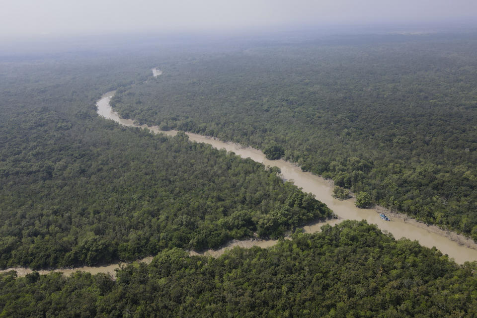 A river flows through the Sundarbans, the world’s largest mangrove forest, near the Maitree Super Thermal Power Project in Rampal, Bangladesh, Tuesday, Oct. 18, 2022. A power plant will start burning coal as part of Bangladesh’s plan to meet its energy needs and improve living standards, officials say. (AP Photo/Al-emrun Garjon)