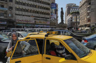 A woman exits a taxi during rush hour in central Damascus, Syria, September 16, 2018. REUTERS/Marko Djurica/Files