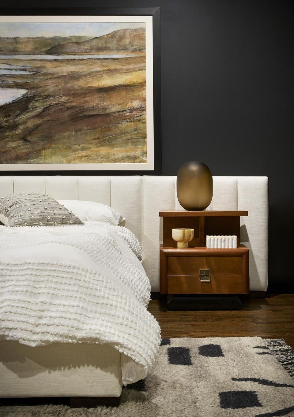 <p>A black and white room makes a stunning canvas for art. For this soulful bedroom, <a href="https://www.chairish.com/shop/studio-sven" rel="nofollow noopener" target="_blank" data-ylk="slk:Studio Sven;elm:context_link;itc:0;sec:content-canvas" class="link ">Studio Sven</a> spotlights an oversized, neutral landscape. </p>