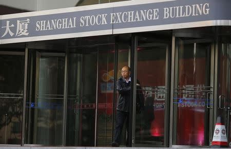 A man walks out of the Shanghai Stock Exchange building at the Pudong financial district in Shanghai November 17, 2014. REUTERS/Carlos Barria/Files