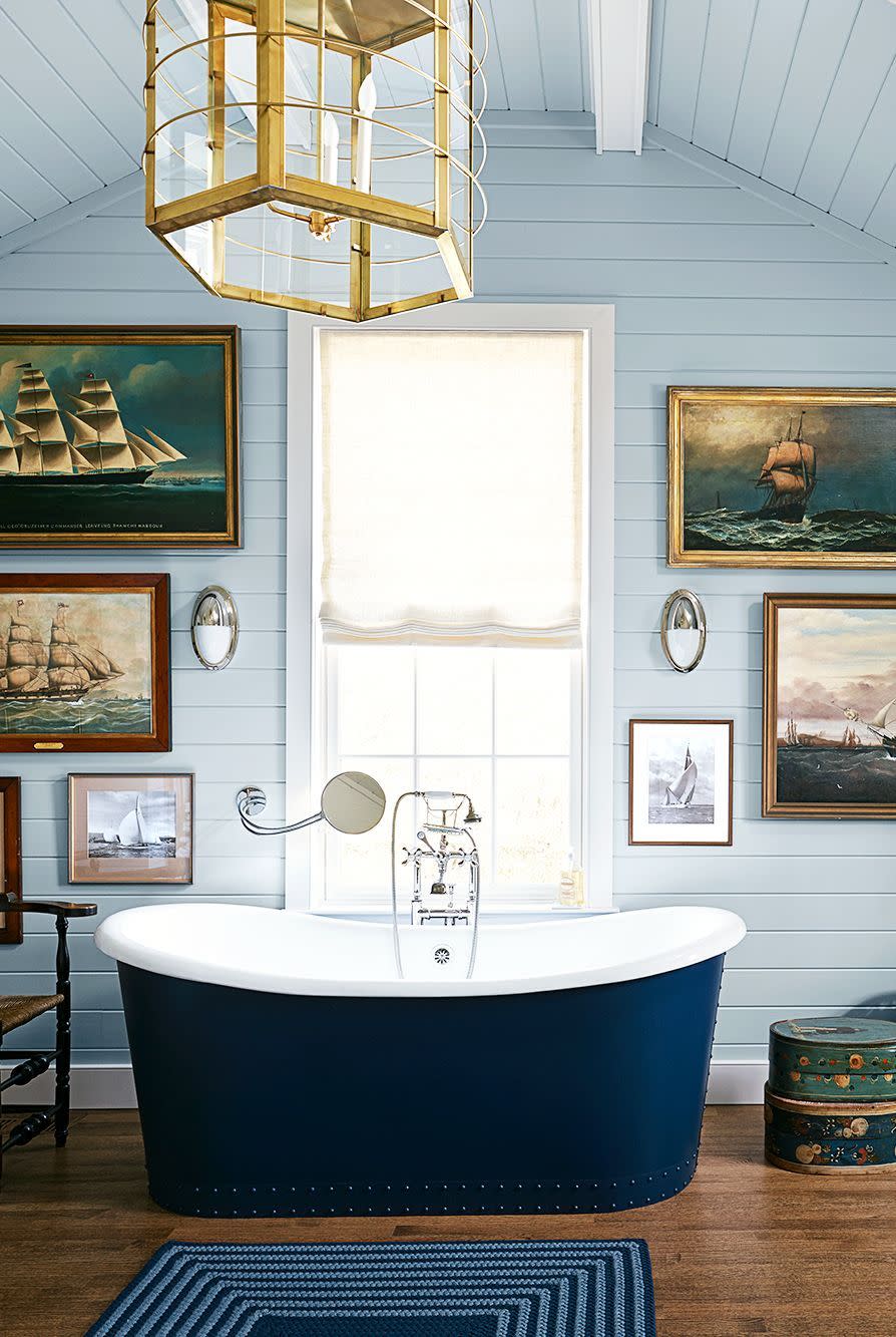 a bathtub in a room with pictures on the wall
