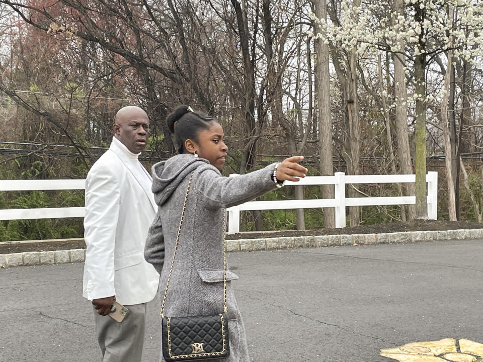 From left, Prince Dwumfour and Nicole Teliano visit the scene of the fatal shooting of their family member, Eunice Dwumfour, in Sayreville, N.J., April 5, 2023. Eunice Dwumfour, a Sayreville council member, was gunned down Feb. 1 as she arrived home in Sayreville. (AP Photo/Maryclaire Dale)