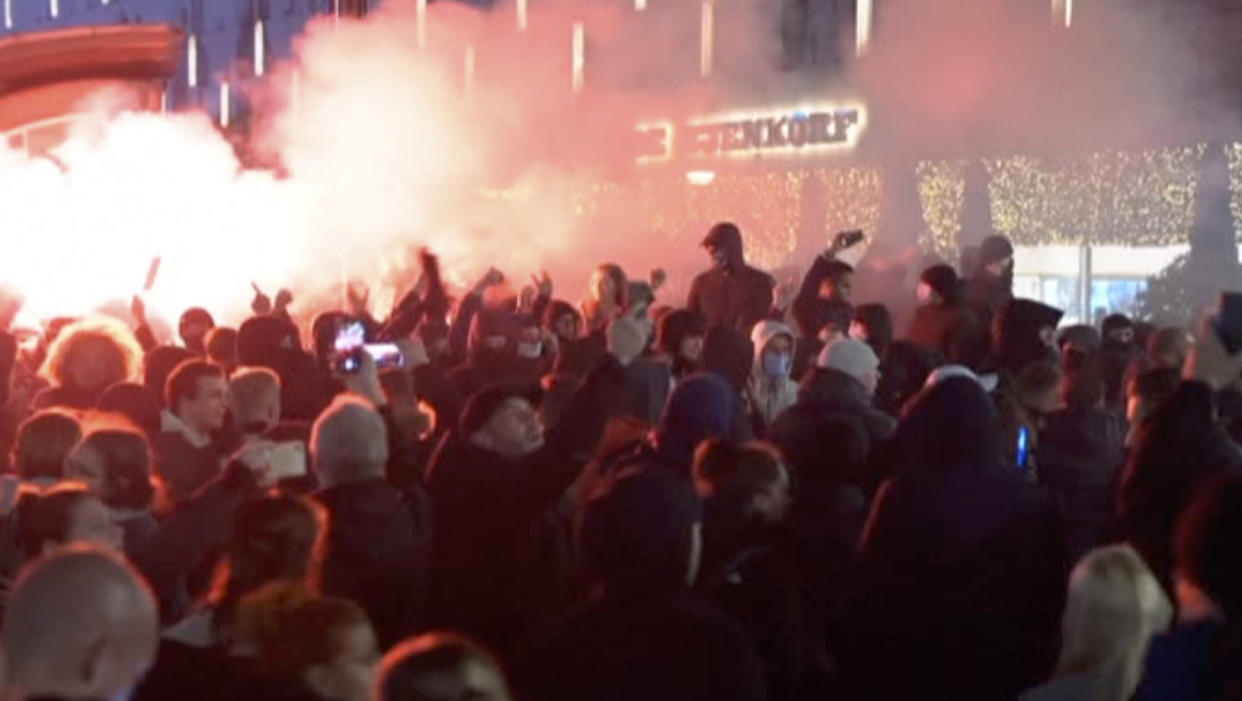 In this image taken from video, demonstrators protest against government restrictions due to the coronavirus pandemic, Friday, Nov. 19, 2021, in Rotterdam, Netherlands. Police fired warning shots, injuring an unknown number of people, as riots broke out Friday night in downtown Rotterdam at a demonstration against plans by the government to restrict access for unvaccinated people to some venues. (Media TV Rotterdam via AP)