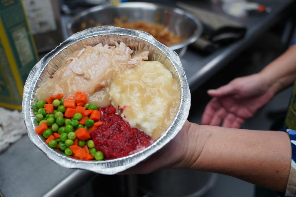 Volunteers prepare individual Thanksgiving meals for seniors in Hawthorne, N.J., on Nov. 3, 2020. With a fall surge of coronavirus infections gripping the U.S., many Americans are forgoing tradition and getting creative with celebrations. (AP Photo/Kathy Young)