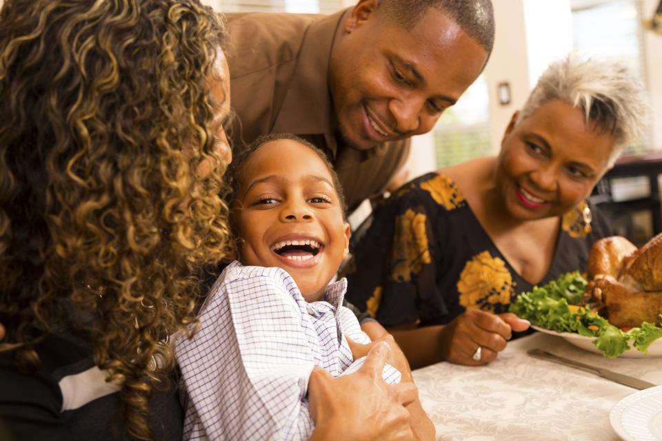 Stock photo of a family gathering for dinner at grandmother's house.