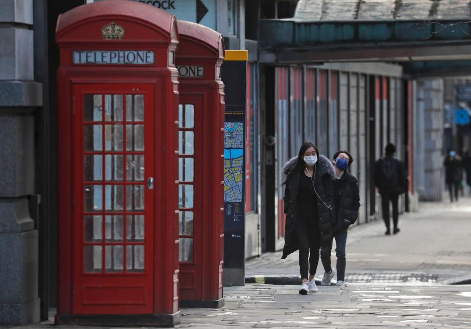 <p>Pedestrians walk through London during England’s third national lockdown</p> (AP)