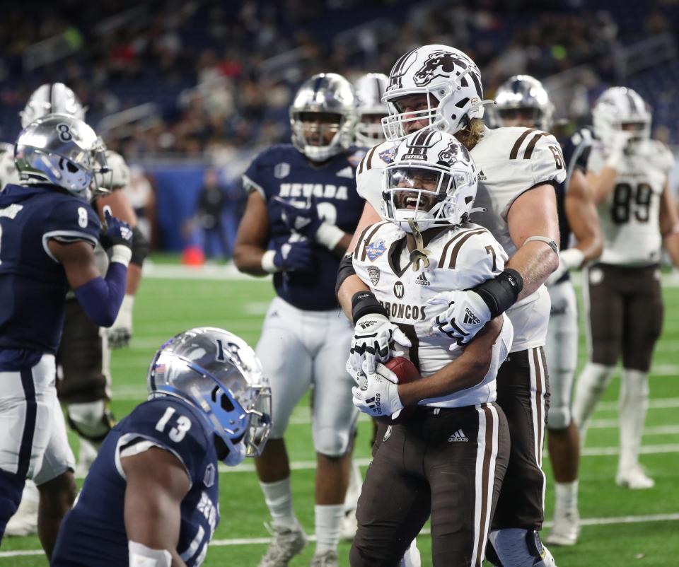 Western Michigan Broncos running back Jaxson Kincaide (7) celebrates with offensive lineman Mark Brooks (60) after his touchdown against the Nevada Wolf Pack during second half action of the Quick Lane Bowl Monday, Dec. 27, 2021, at Ford Field.