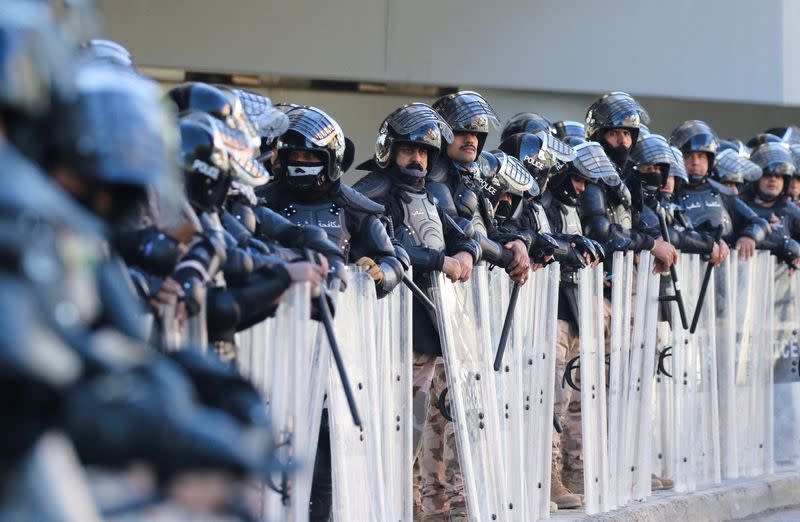 Iraqi riot police stand by as supporters of Iraqi Shiite parties disputing the vote results gather before the final verdict ratifying election results is issued by Iraq's Supreme Court, in Baghdad