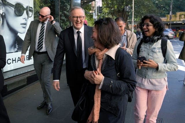 Australian Prime Minister Anthony Albanese, second left, interacts with members of the public as he walks in central Sydney after a press briefing on Wednesday