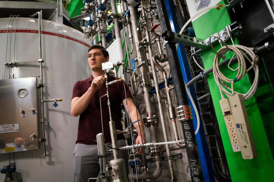 Duncan Kroll, a graduate research assistant, shows a helium purifier he works on inside the Facility for Rare Isotope Beams (FRIB) at Michigan State University in East Lansing on Tuesday, Aug. 1, 2023.
