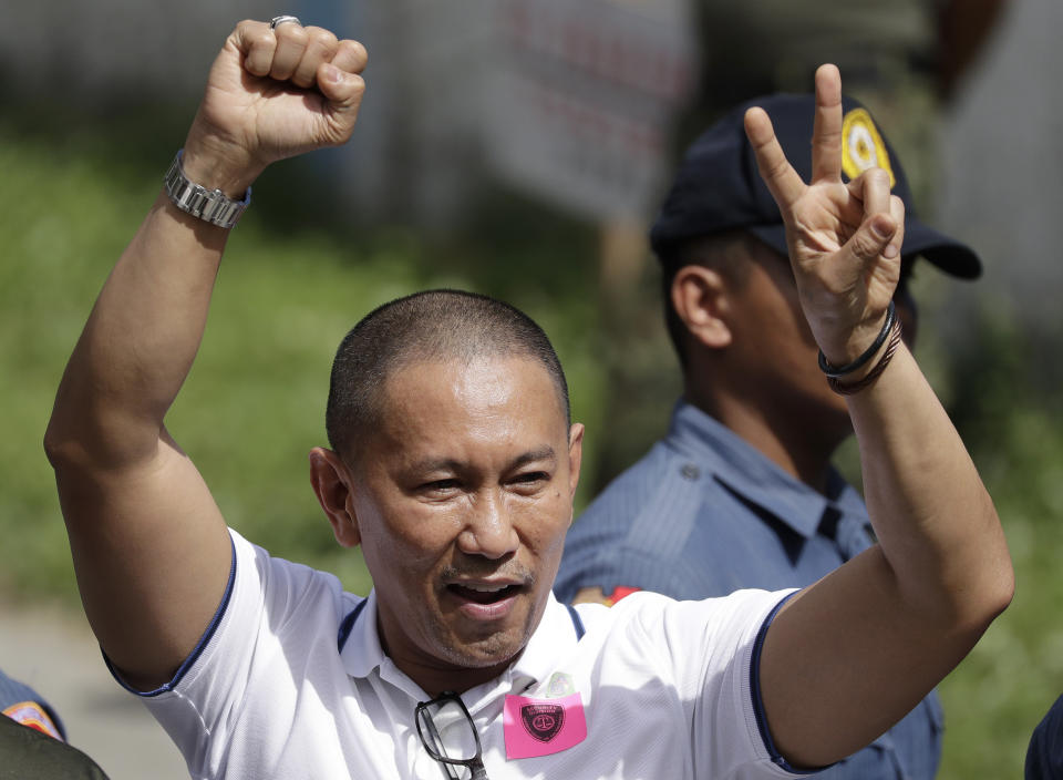 House representative Esmael Mangudadatu, center, whose wife and relatives were victims in a 2009 election-related killings, gestures as he steps out a court at Camp Bagong Diwa, suburban Taguig, Philippines, Thursday, Dec. 19, 2019. The Philippine court on Thursday found key members of a powerful political clan guilty of a 2009 massacre in a southern province that left 57 people, including 32 media workers, dead in a brazen act that horrified the world. (AP Photo/Aaron Favila)