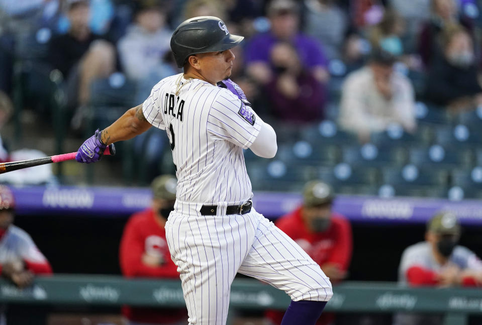 Colorado Rockies' Yonathan Daza connects for an RBI-single of Cincinnati Reds starting pitcher Wade Miley in the third inning of a baseball game Friday, May 14, 2021, in Denver. (AP Photo/David Zalubowski)