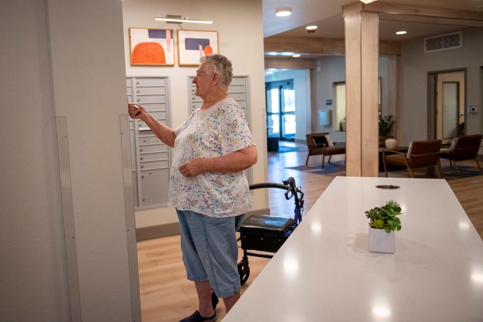 Cadence resident Rosalee Blumenshine checks her mail at her residence on Thursday. Cadence, built by Volunteers of America at 2555 Joseph Allen Drive, is a new Fort Collins senior housing project built for lower-income residents.