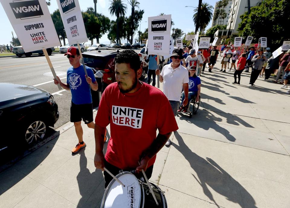 Members of Unite Here Local 11 and members of the Writers Guild of America picket together