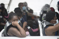 Migrants wait on a boat before departing for Capurgana, on the border with Panama, from Necocli, Colombia, Thursday, July 29, 2021. Migrants have been gathering in Necocli as they move north towards Panama on their way to the U.S. border. (AP Photo/Ivan Valencia)