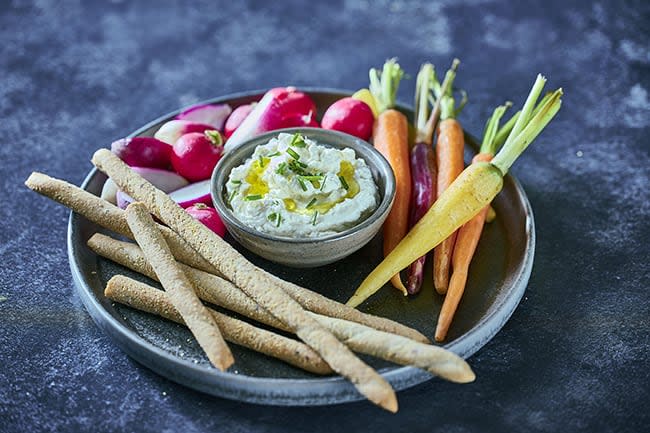 Whipped feat on a plate with carrot and tomato