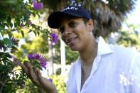 Artist Lady PheOnix poses for a photograph in an augmented reality (AR) garden titled "Breonna's Garden" honoring the late Breonna Taylor at the Maurice A. Ferre Park next to the Perez Art Museum during Miami Art Week, Friday, Dec. 3, 2021, in Miami. The project was created in a collaboration between Lady PheOnix and Taylor's sister Ju'Niyah Palmer. (AP Photo/Lynne Sladky)