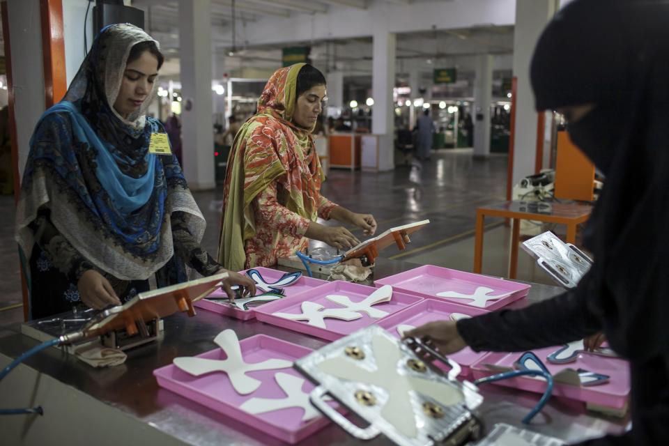 Employees work in the production area inside the soccer ball factory that produces official match balls for the 2014 World Cup in Brazil, in Sialkot, Punjab province