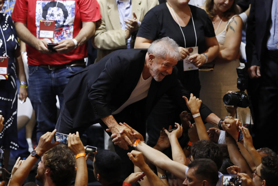 Former Brazilian President Luiz Inacio Lula da Silva greets supporters during the Workers' Party 7th Congress, in Sao Paulo, Brazil, Friday, Nov. 22, 2019. Da Silva is the unquestioned star of the PT 3-day party convention. Many still think he could be the party's standard-bearer once again in 2022 - when he'll be a 77-year-old cancer survivor who is now barred from seeking office due to a corruption conviction. (AP Photo/Nelson Antoine)