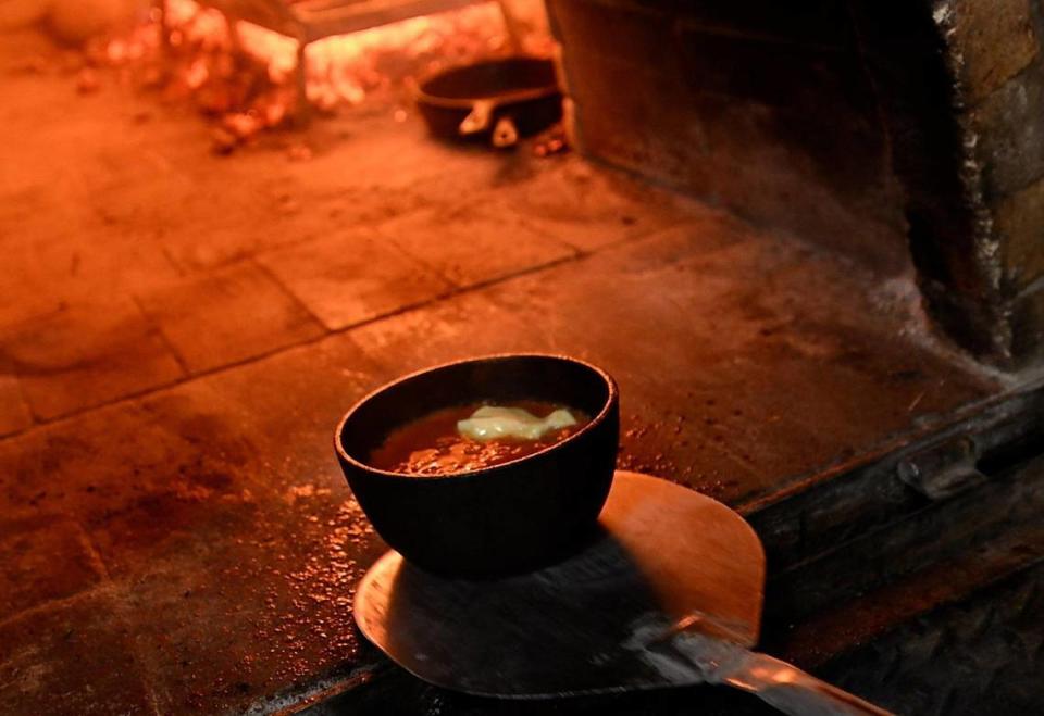 Chirbuli goes into a cast-iron bowl and then gets cooked in a wood-burning oven.