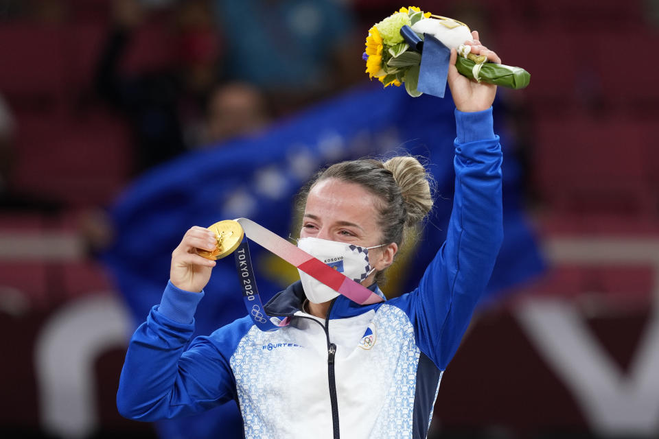 Gold medalist Distria Krasniqi of Kosovo reacts during the medal ceremony for women's -48kg judo at the 2020 Summer Olympics, Saturday, July 24, 2021, in Tokyo, Japan. (AP Photo/Vincent Thian)