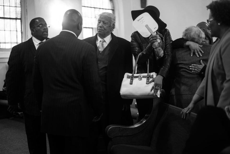 <p>Spencer Leak greets membres of a family at a funeral he helped organize on Chicago’s south side. (Photo: Jon Lowenstein/NOOR for Yahoo News) </p>