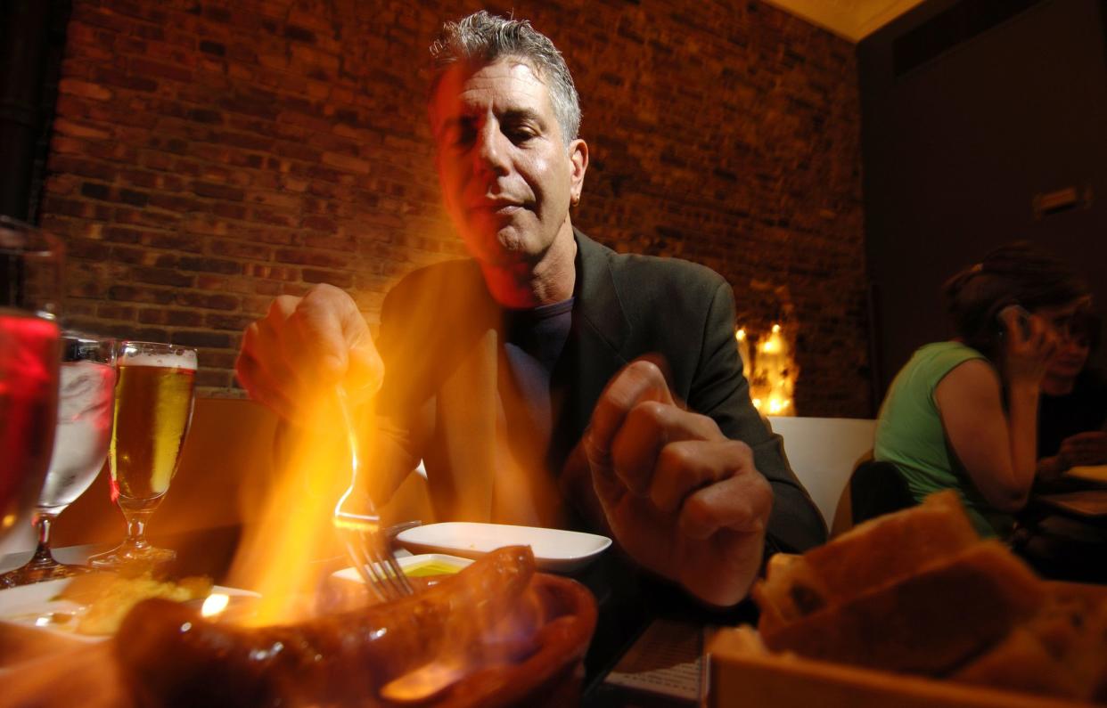 Anthony Bourdain tastes a meal prepared for him at the Times Square restaurant Tintol on April 12, 2006.