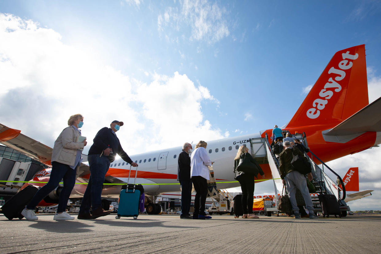 EasyJet  EDITORIAL USE ONLY Passengers board the first holiday and leisure flight at Gatwick Airport, destined for Faro, Portugal as easyJet relaunch flights from the UK to green-lit destinations today, for the first time this year. Picture date: Monday May 17, 2021.