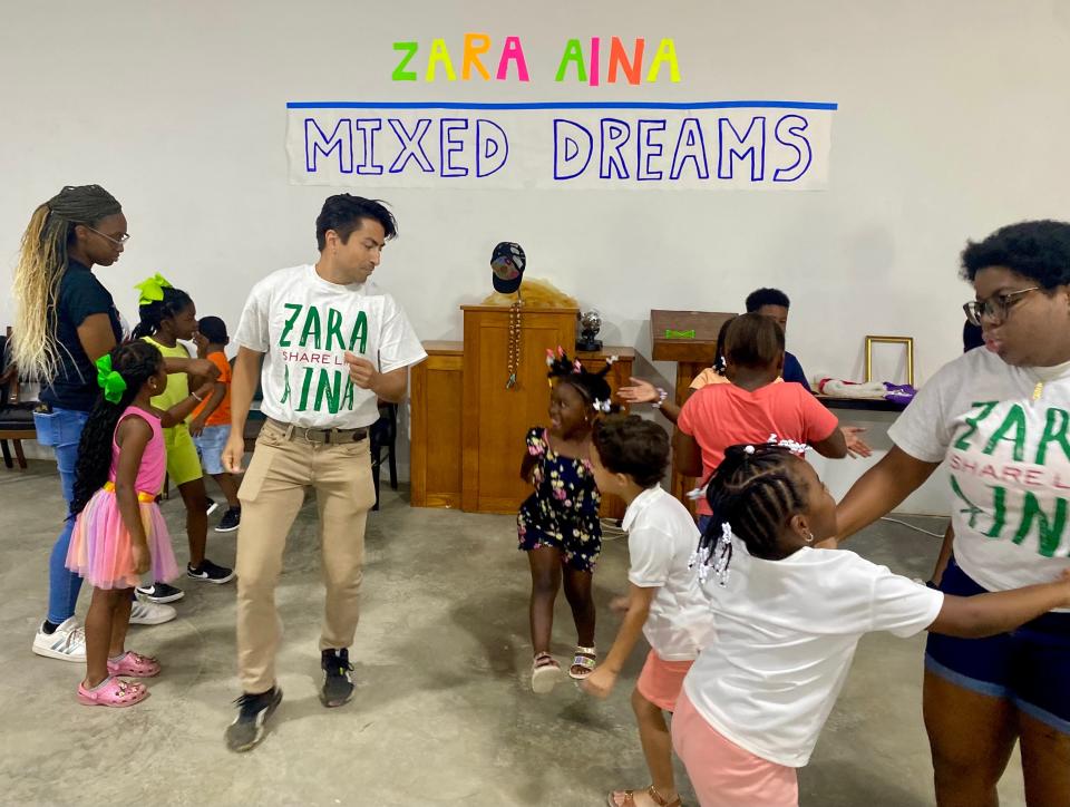 Shaun Taylor-Corbett and Tina Canady ready younger children for the first act of a “Dream a Little Dream of Me” performance in Camden, Alabama, on July 2.