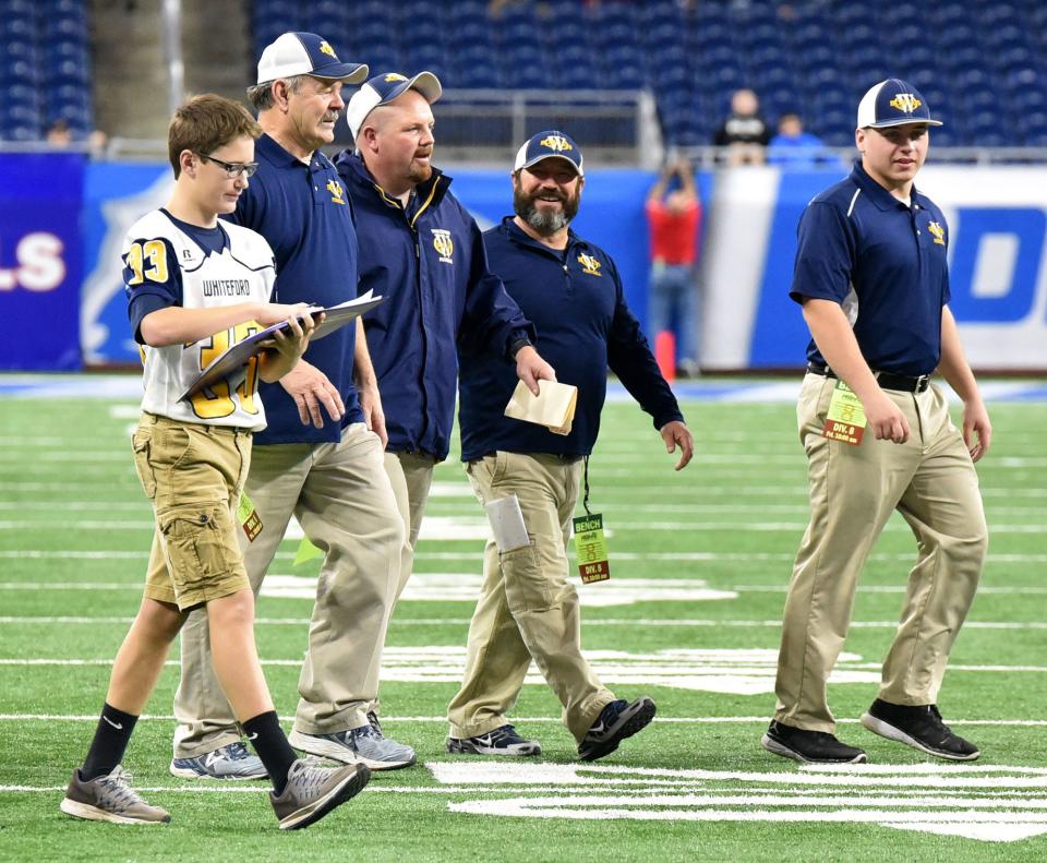 Whiteford football coaches (left to right) Bob Ondrovick, Jason Mensing, John Nagle and Kevin Kaufman leave Ford Field in Detroit after the Bobcats won the Division 8 state championship in 2017.