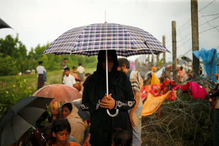 A Rohingya woman reacts to the camera as she wait for boat to cross the border through Naf river in Maungdaw, Myanmar, September 7, 2017. REUTERS/Mohammad Ponir Hossain