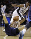 Dallas Mavericks' Dirk Nowitzki, bottom, of Germany, falls to the floor as he and San Antonio Spurs' Boris Diaw (33), of France, chase a loose ball during the first half of Game 2 of the opening-round NBA basketball playoff series on Wednesday, April 23, 2014, in San Antonio. (AP Photo/Eric Gay)