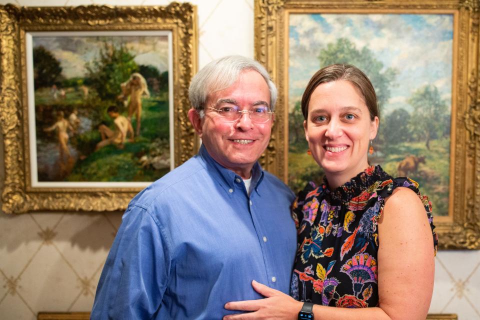 Segundo J. Fernandez and his wife, Bobbie C. Fernandez, photographed in front of paintings by William Mark Fisher R.A. (1843-1923), American impressionist, in their home on Thursday, Oct. 5, 2023.