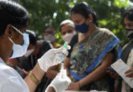 A health worker prepares to administer COVID-19 vaccine in Hyderabad, India, Thursday, Oct. 21, 2021. India has administered 1 billion doses of COVID-19 vaccine, passing a milestone for the South Asian country where the delta variant fueled its first crushing surge this year. (AP Photo/Mahesh Kumar A.)