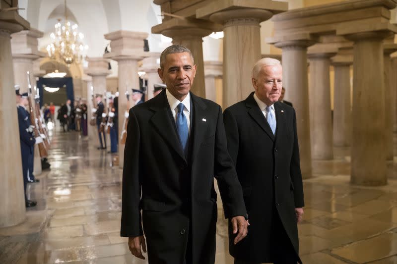 FILE PHOTO: President Barack Obama and Vice President Joe Biden walk through the Crypt of the Capitol in Washington