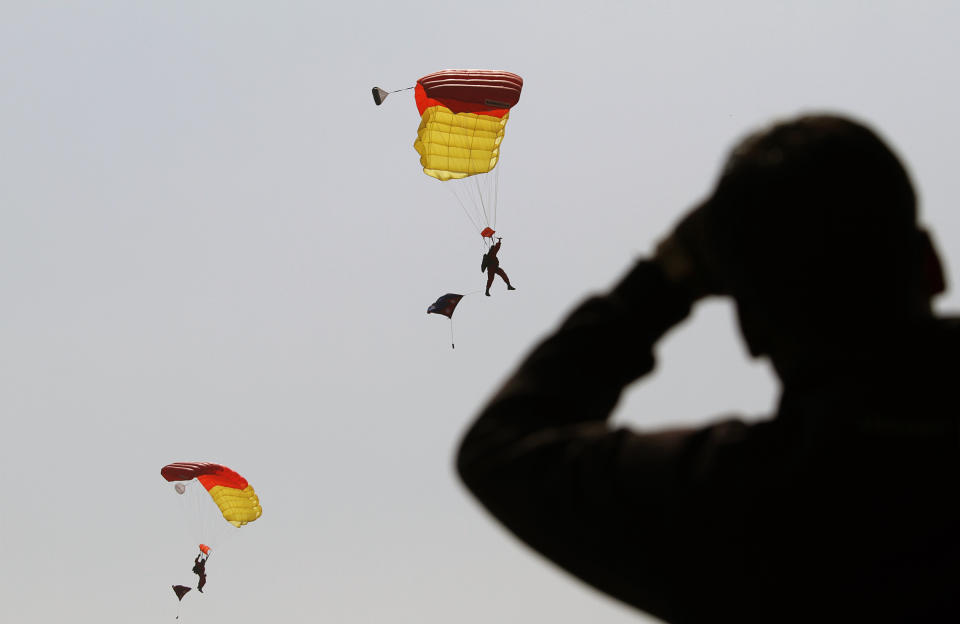 Nepalese army soldiers demonstrate paragliding skills in a parade to mark Army Day in Katmandu, Nepal, Monday, Feb. 20, 2012. Nepal's Army Day is celebrated annually on Mahashivratri, a festival dedicated to Hindu God Shiva. (AP Photo/Niranjan Shrestha)