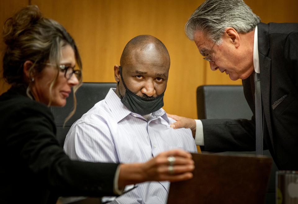 Convicted murderer Marcelle Waldon listens as his attorneys, Debra Tuomey, left, and Daniel Hernandez, right, try to convince him to put on a mitigation defense during the penalty phase of his trial Monday in Bartow. The jury that convicted Waldon of murdering Edie Yates Henderson and David Henderson now will make a recommendation for the death penalty or life imprisonment.