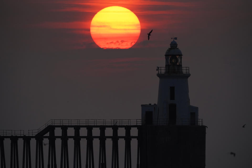 <p>The sun rises through the sea mist at Blyth pier in Northumberland. Picture date: Tuesday July 27, 2021. (Photo by Owen Humphreys/PA Images via Getty Images)</p>
