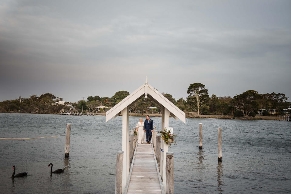 Mr and Mrs Forde are seen standing on a pier at the Paynesville property after their nuptials. Source: Rebecca Farley Photography