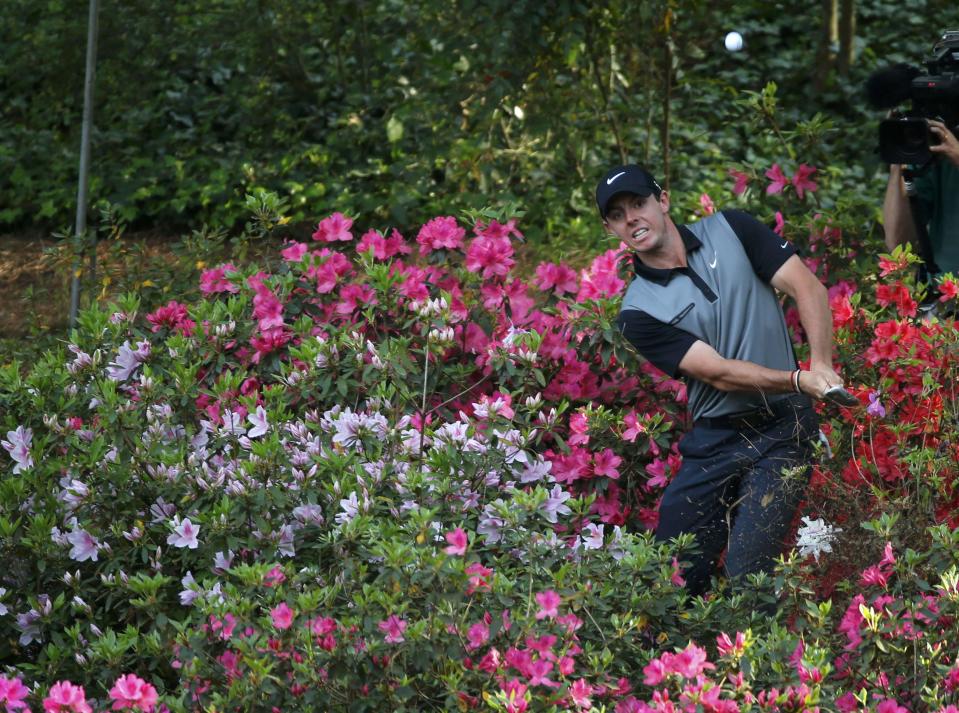 Northern Ireland's Rory McIlroy hits from the azaleas on the 13th hole during the second round of the Masters golf tournament at the Augusta National Golf Club in Augusta, Georgia April 11, 2014. REUTERS/Mike Blake (UNITED STATES - Tags: SPORT GOLF)