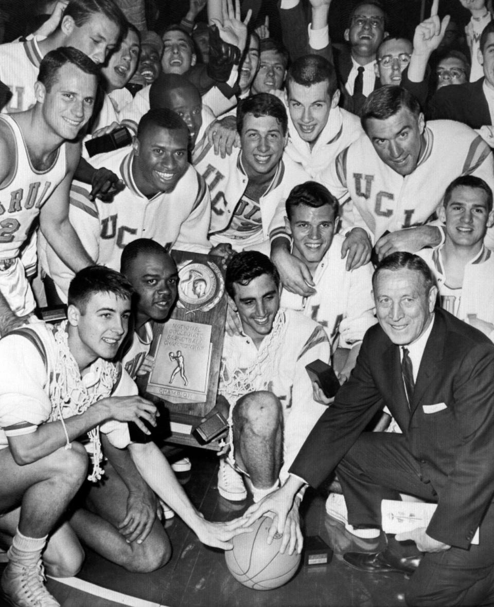 John Wooden and his UCLA team celebrate a win in 1964 with a group photo