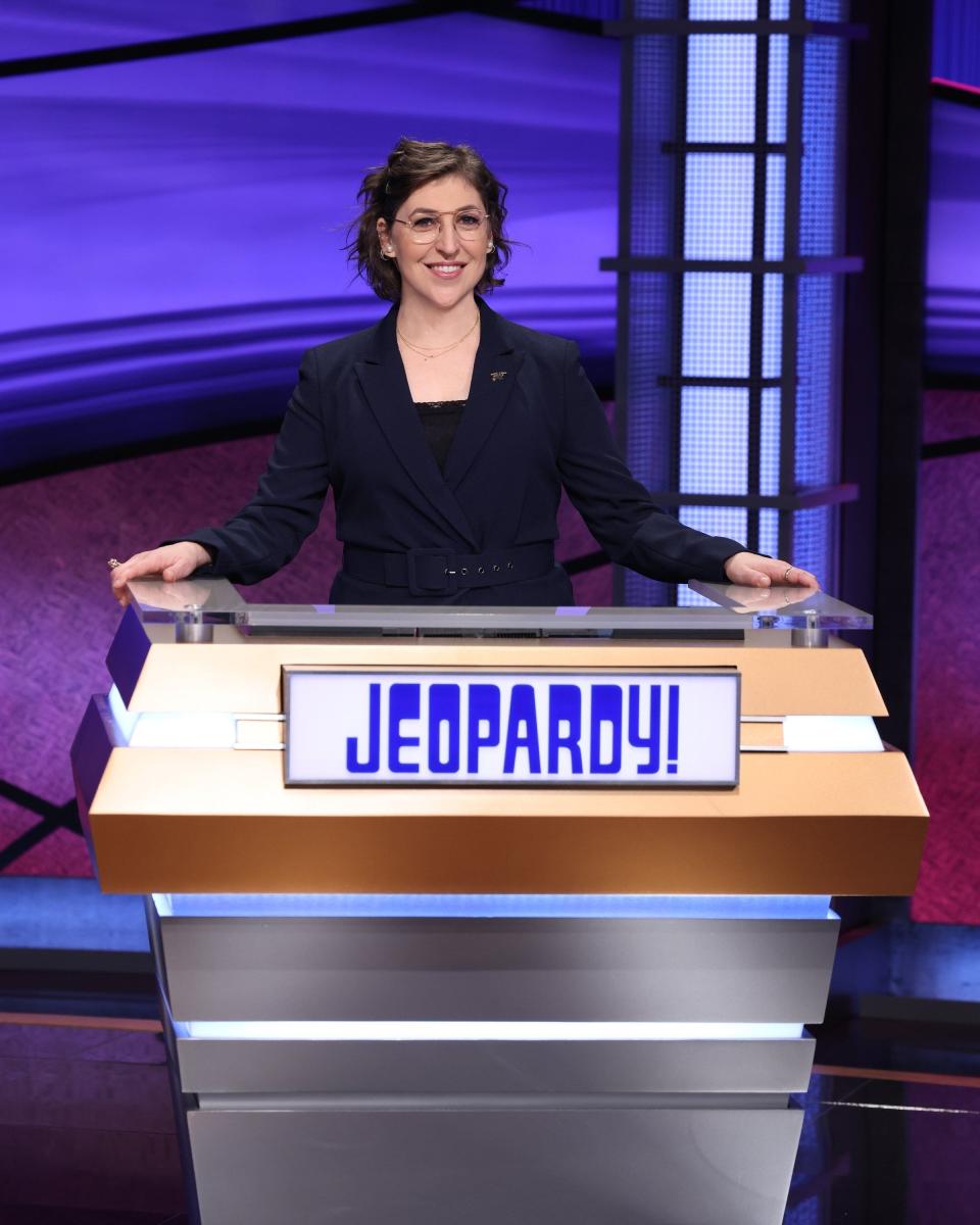 Mayim Bialik photographed behind the "Jeopardy!" podium.