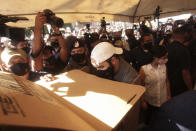 President Nayib Bukele prepares his ballots behind a privacy screen as he votes in local and legislative elections, in San Salvador, El Salvador, Sunday, Feb. 28, 2021. El Salvador went to the polls in legislative and mayoral elections that could break the congressional deadlock that has tied the hands of President Bukele.(AP Photo/Salvador Melendez)