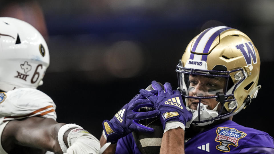 Washington wide receiver Rome Odunze (1) makes the catch against Texas during the second half of the Sugar Bowl CFP NCAA semifinal college football game, Monday, Jan. 1, 2024, in New Orleans. (AP Photo/Gerald Herbert)