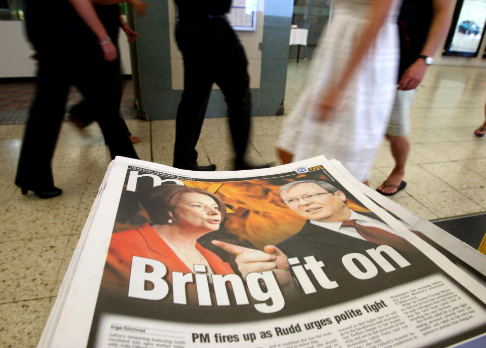 Photos of Australian Prime Minister Julia Gillard, left, and former Foreign Minister Kevin Rudd, are displayed on a newspaper at a train station Thursday, Feb. 23, 2012, in Sydney. Rudd, who resigned as foreign minister Wednesday during an official visit to the U.S., told reporters in Washington that night that he thinks Labor will lose next year's elections if Gillard remains leader, and that government colleagues are encouraging him to run in a a leadership ballot. (AP Photo/Rick Rycroft)