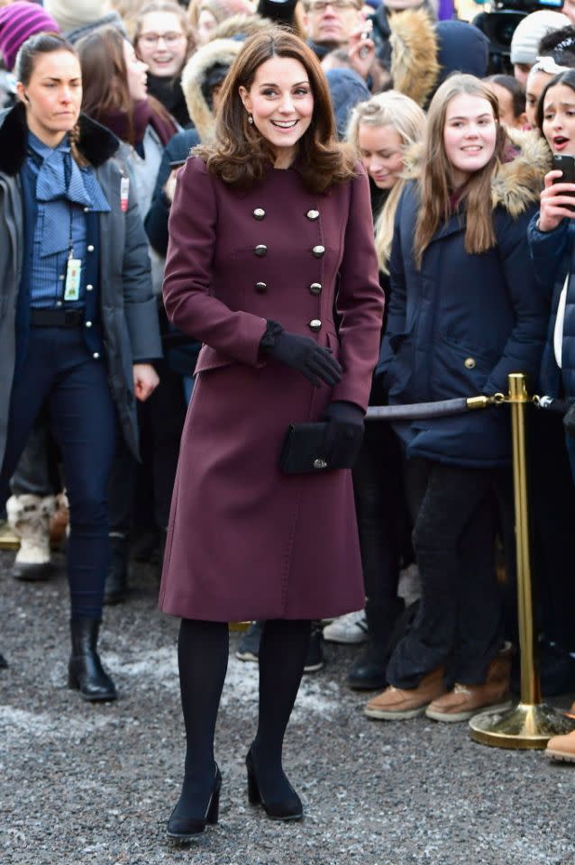 <p>To mark the final stint of the royal couple’s tour, the Duchess of Cambridge donned a burgundy-hued coat by Dolce and Gabbana. She accessorised the look with her go-to Tod’s block heels ($288) and a Mulberry clutch ($865). </p>