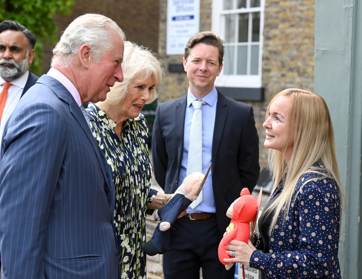 CLAPHAM, ENGLAND - MAY 27: Prince Charles, Prince of Wales and Camilla, Duchess of Cornwall who gets presented with a Boris Johnson dog toy during a visit to Clapham old town on May 27, 2021 in Clapham, England. (Photo by Karwai Tang/WireImage)