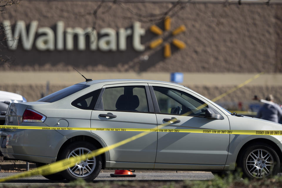 Crime scene tape surrounds a car at the scene of a mass shooting at a Walmart, Wednesday, Nov. 23, 2022, in Chesapeake, Va. A Walmart manager opened fire on fellow employees in the break room of the Virginia store, killing several people in the country’s second high-profile mass shooting in four days, police and witnesses said Wednesday. (AP Photo/Alex Brandon)